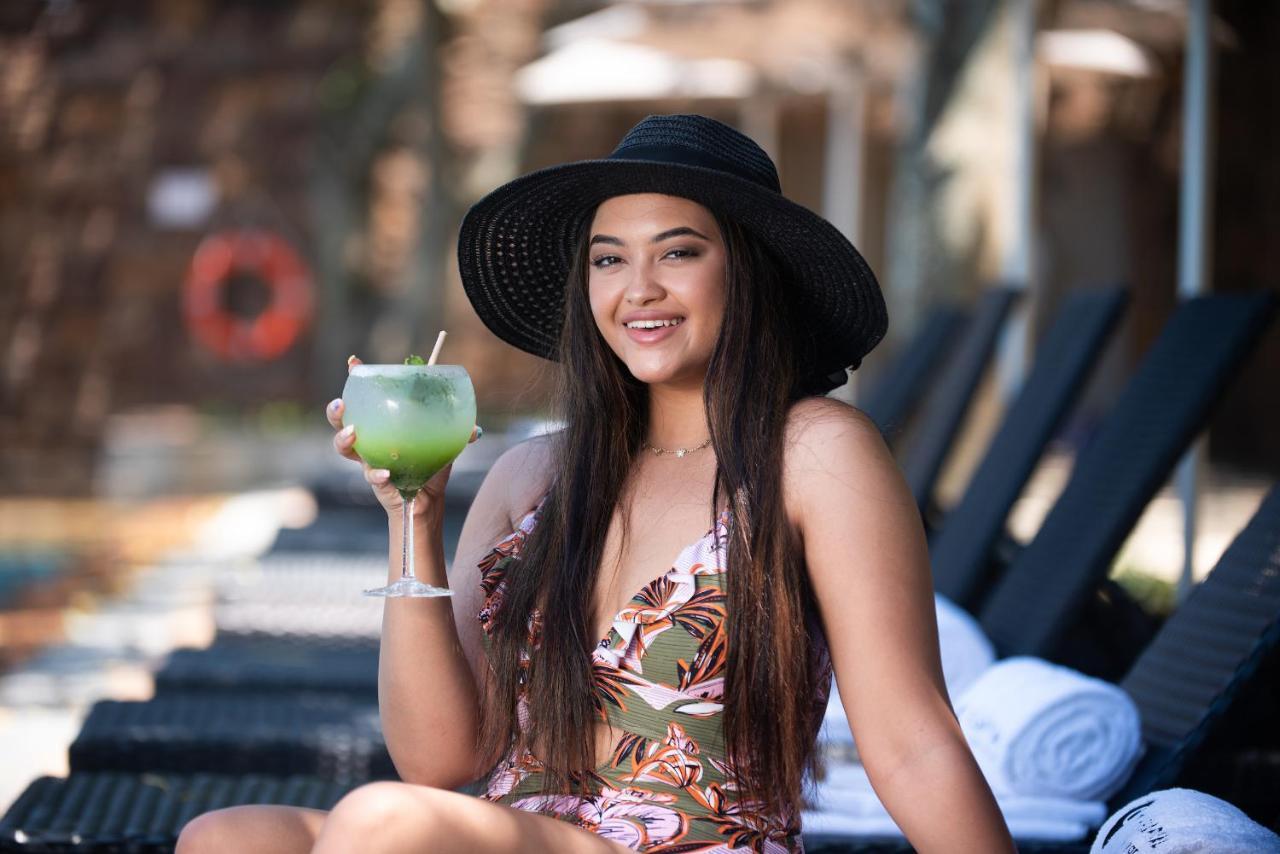 ホテル The Capital Zimbali バリート エクステリア 写真 A woman wearing a sun hat